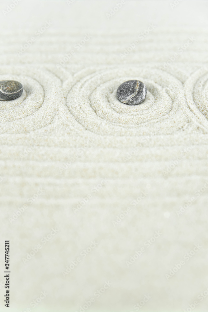 Zen garden. Pyramids of white and gray zen stones on the white sand with abstract wave drawings. Concept of harmony, balance and meditation, spa, massage, relax. Zen garden. Pyramids of white and gray zen stones on the white sand with abstract wave drawings. Concept of harmony, balance and meditation, spa, massage, relax.