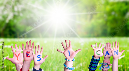 Children Hands Building Colorful Word Yes I Can. Green Grass Meadow As Background