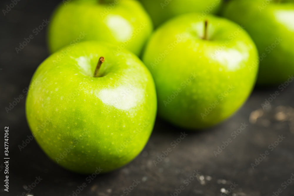 Close-up green apples on the rustic wooden background Close-up green apples on the rustic wooden background