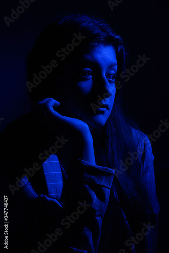 Female portrait in the studio of Blue Light