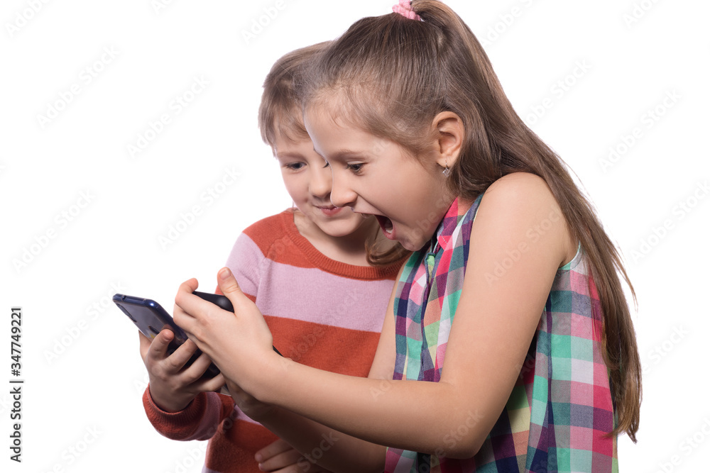 Two cute little girls posing with mobile phones. Two cute little girls posing with mobile phones.