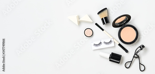 Beauty cosmetics makeup product flying. Woman make up, brushes lipstick falling in air. Creative fashion concept on white. Cosmetology make-up design color set fly, levitation.