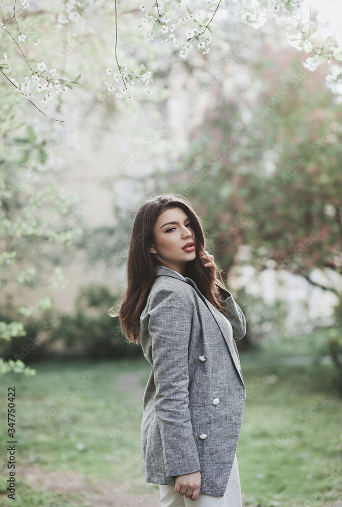 l happy smiling lady posing near flowering tree l happy smiling lady posing near flowering tree