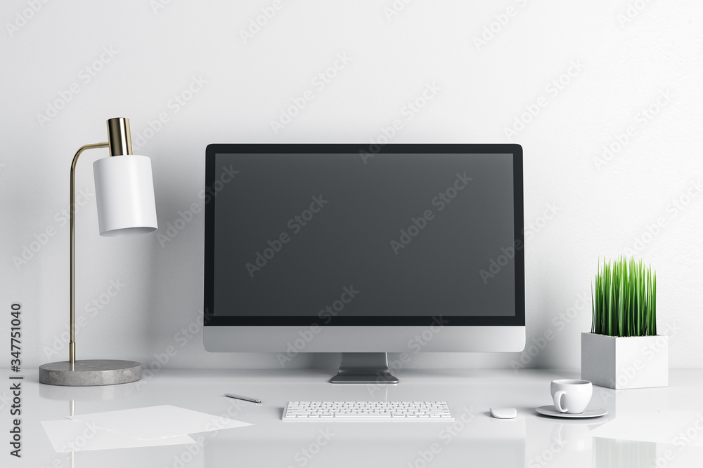 Fototapeta premium Stylish designer desktop with empty computer screen and lamp on table.