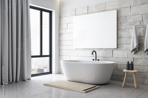 Modern bathroom with blank poster on wall