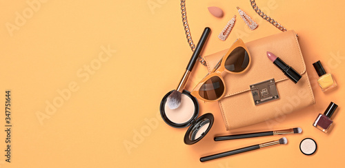 Beauty cosmetic makeup set. Fashion woman make up product, brushes, lipstick, nail polish orange collection. Creative concept. Cosmetology make-up accessories banner, top view.