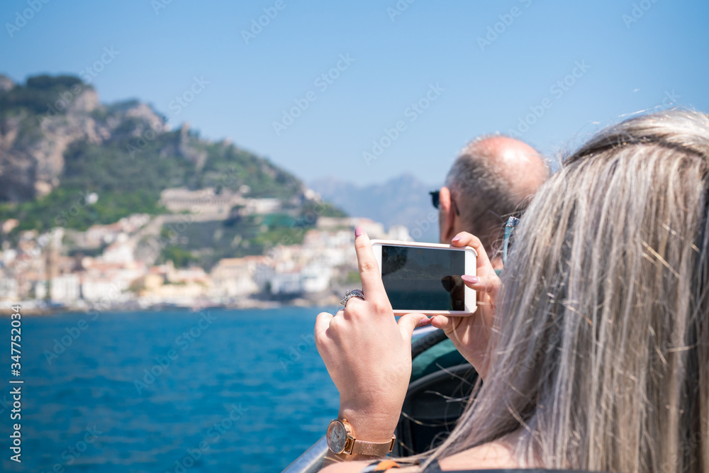 Tourists enjoy the stunning Gulf of Salerno at the bay of Amalfi, Italy.
