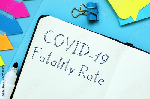 Conceptual photo about covid fatality rate with handwritten phrase.