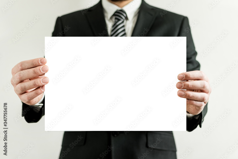 Young executive shows a white picture. Young executive shows a white picture.