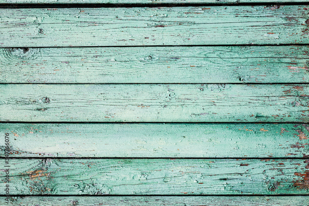 Fototapeta premium A light green old painted horizontal wooden planks texture