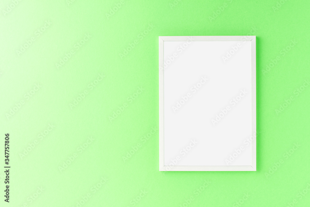Empty photo frame hanging on green wall. Mockup Empty photo frame hanging on green wall. Mockup