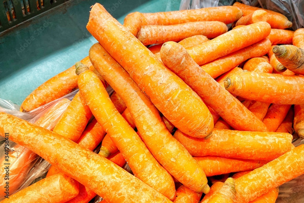Fresh carrots and potatoes in the store. A close-up. Mobile photo. Fresh carrots and potatoes in the store. A close-up. Mobile photo.
