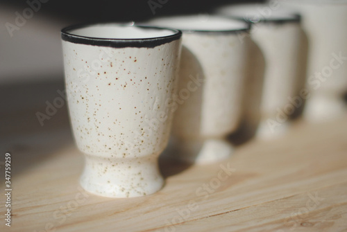 empty white glasses and cups of restaurant and cafe on a light background.
