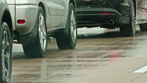 Car moving and stopping in traffic jam on rainy American highway