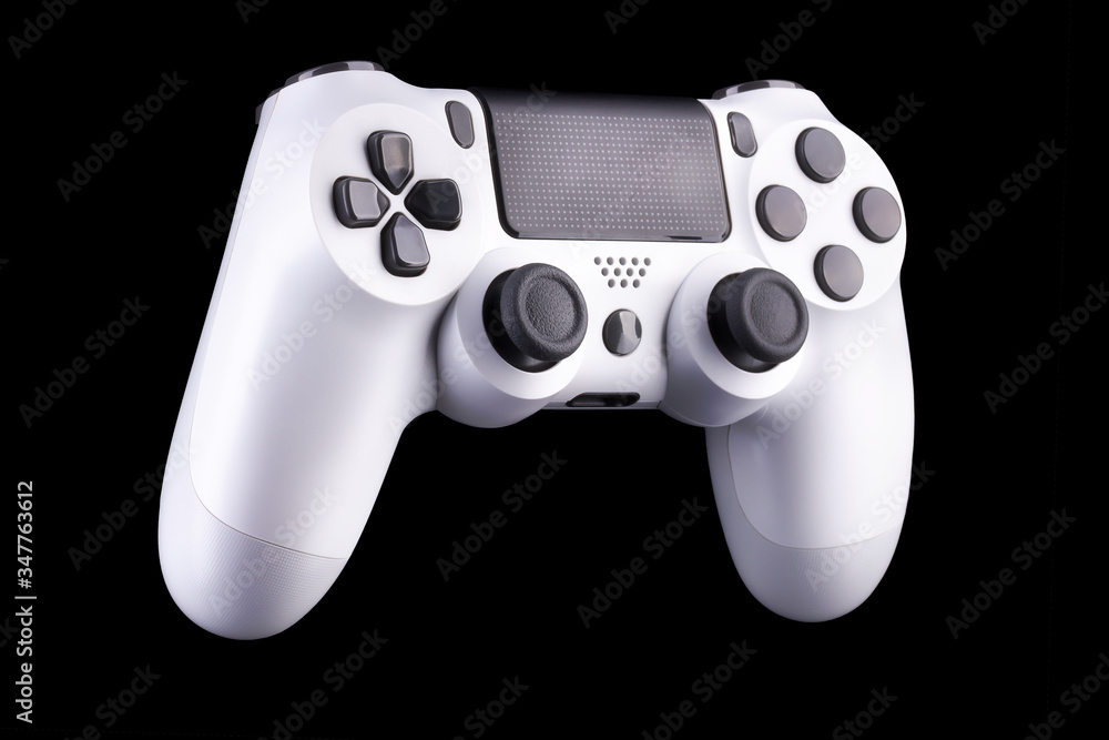 White video game joystick gamepad isolated on a black background White video game joystick gamepad isolated on a black background