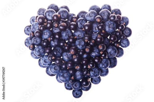  Heart shape made of delicious fresh blueberries and black currants isolated on white background as a design element for love concept - Valentine's Day and Mother's Day. Top view. Studio shot