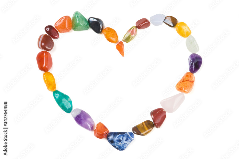 Loving Gems - Luxury heart shape made of mixed semi-precious gem stones on white background with shadow. Design element for love concept - Valentine's Day and Mother's Day. Top view. Studio shot Loving Gems - Luxury heart shape made of mixed semi-precious gem stones on white background with shadow. Design element for love concept - Valentine's Day and Mother's Day. Top view. Studio shot