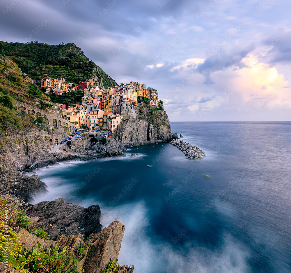 View of Manarola village at sunset. Manarola is one of famous villages of the Cinque Terre - a beautiful coastal area on the north of Italy. Italy, Europe