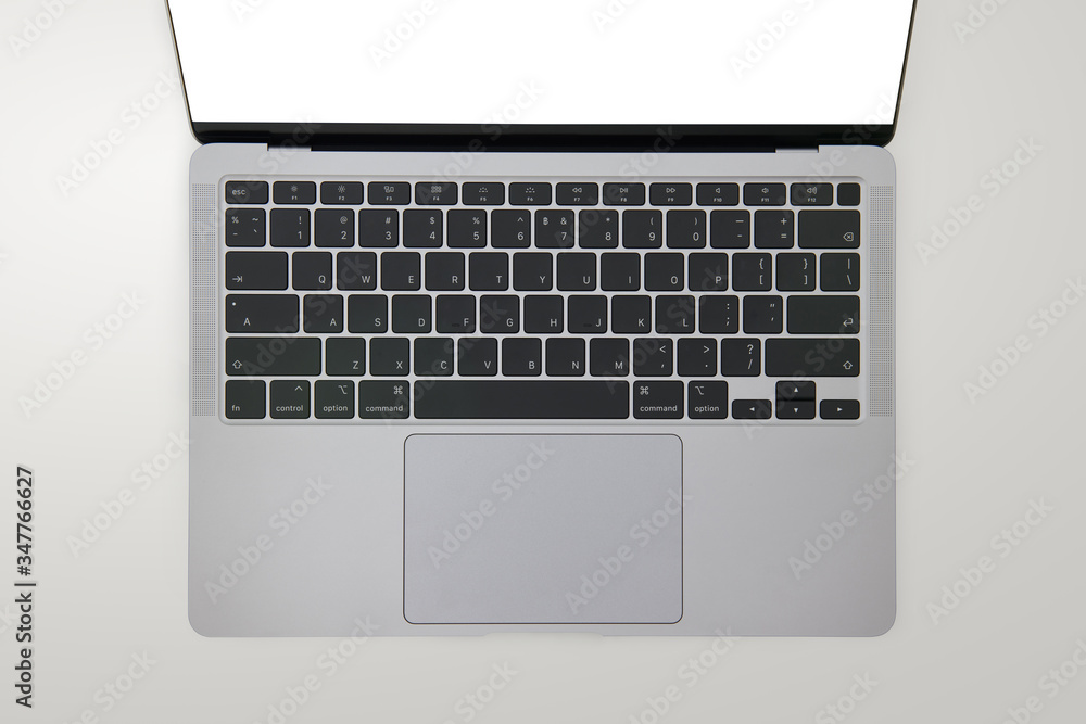 Close-up top view of ultrabook, a thin and light laptop, in space grey color on white isolated background Close-up top view of ultrabook, a thin and light laptop, in space grey color on white isolated background