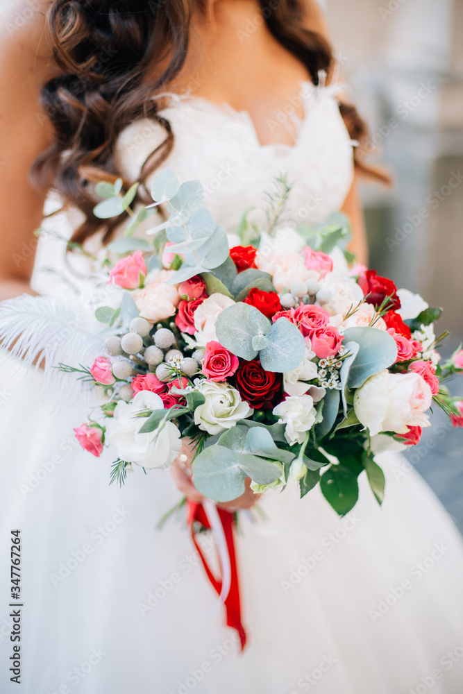 Wedding bouquet of flowers held by bride closeup