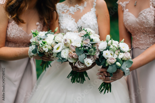 Wedding bouquets in the hands of the bride and bridesmaids