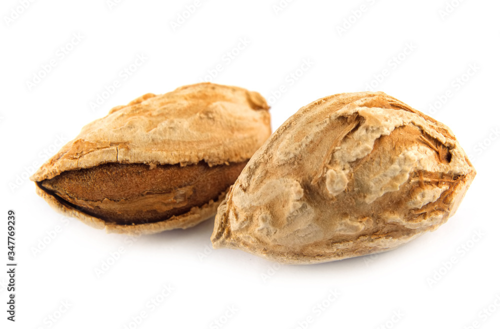 Close-up of two almonds, isolated on white background Close-up of two almonds, isolated on white background