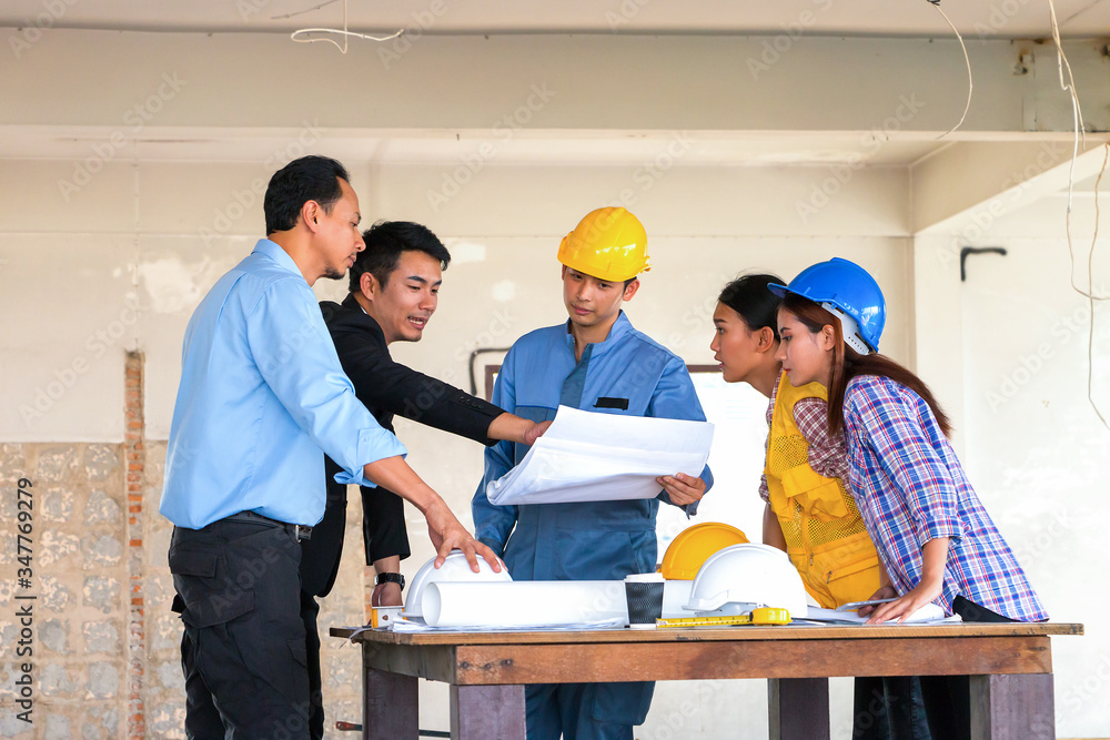 Engineer and worker team meeting and having problem about his project at construction site.