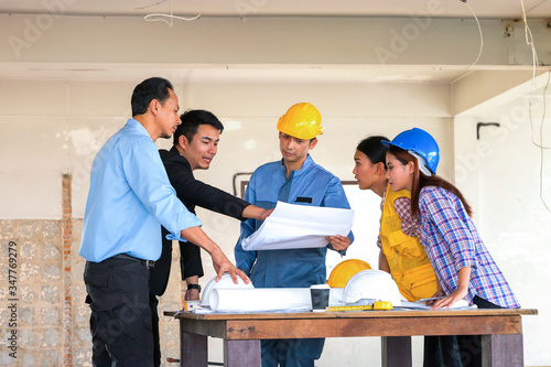 Engineer and worker team meeting and having problem about his project at construction site.