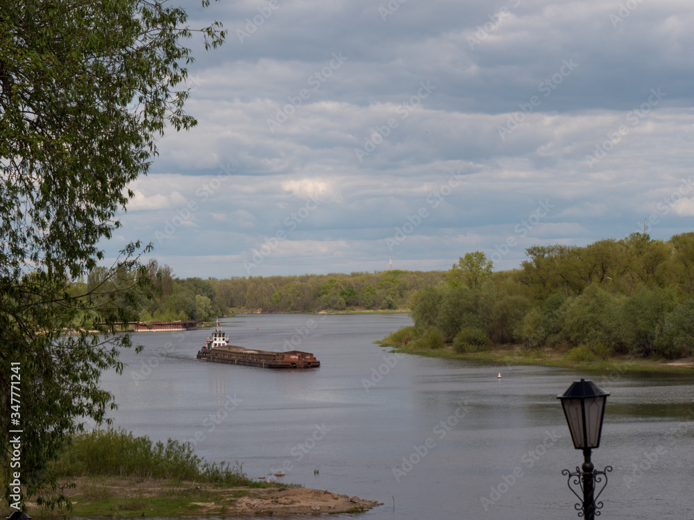 barge goes on the river in spring