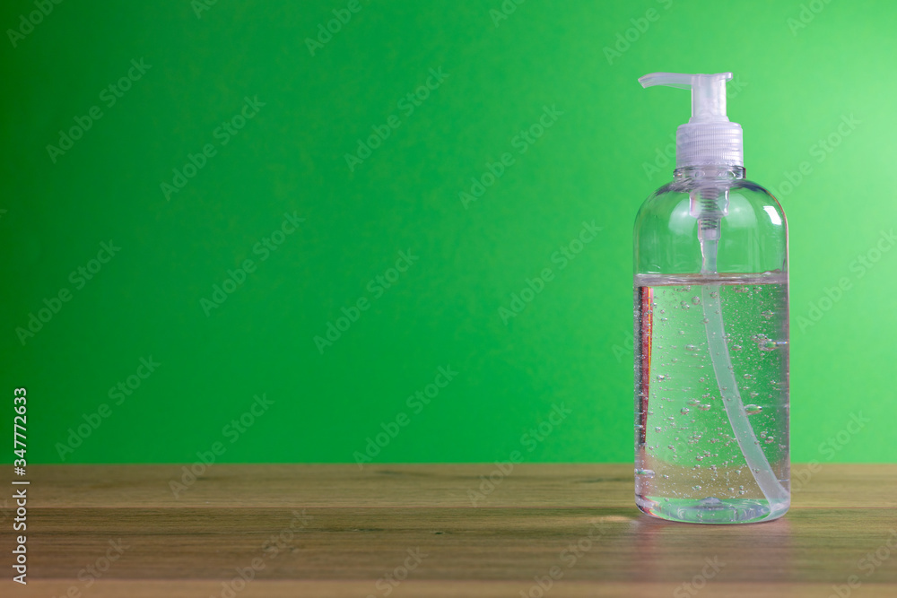 hand sanitizing gel in transparent plastic container with green background, coronavirus prevention, covid-19 hand sanitizing gel in transparent plastic container with green background, coronavirus prevention, covid-19