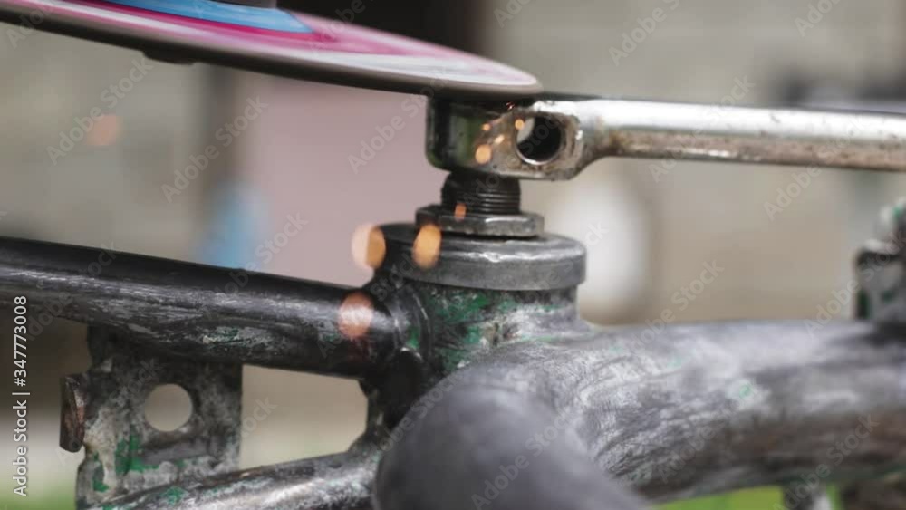 Metal worker grinding metal with a power machine. Metal worker grinding metal with a power machine.