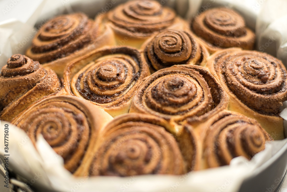 Fototapeta premium Fresh rolls Cinnabon, Cinnamon rolls in the form. Flavorful pastries