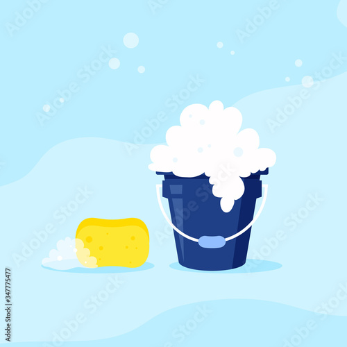 Spring cleaning concept. Blue bucket with foam and sponge. 