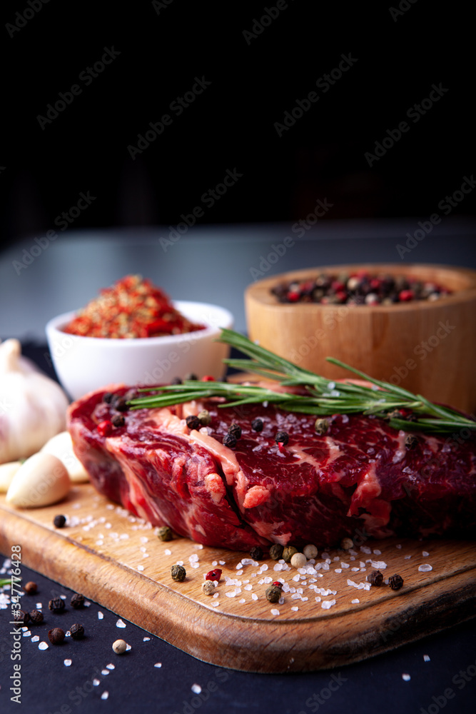 Fresh steak with a set of spices on a cutting board Fresh steak with a set of spices on a cutting board
