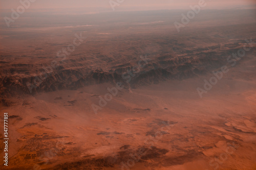 Photo of desert from the plane. View from above.  Situational plan with alien landscape. © Sunnyside