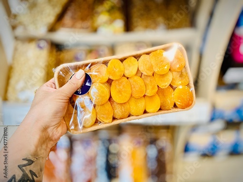 Different nuts and dried fruits in the package in the supermarket. A close-up. Mobile photo.
