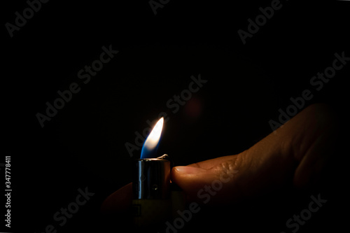 flame of a lighter with a hand