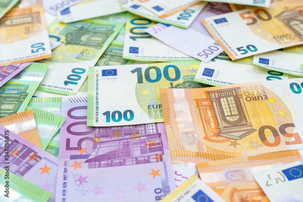 European currency lies on the table. Banknotes one hundred, two hundred, fifty, five hundred euros are scattered in a chaotic manner. Blank for design, background. Side view.