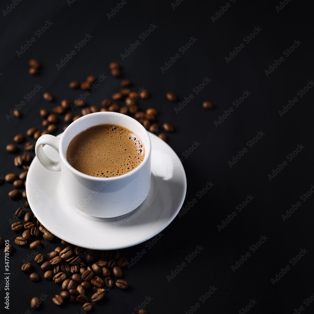 a white espresso Cup on a black concrete table top view of copy space