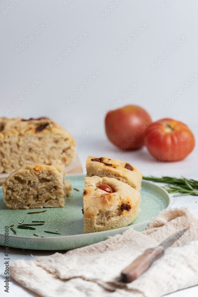 Italian bread with rosemary, dried tomatoes, cherry tomatoes and oil. Homemade bread. Italian bread with rosemary, dried tomatoes, cherry tomatoes and oil. Homemade bread.