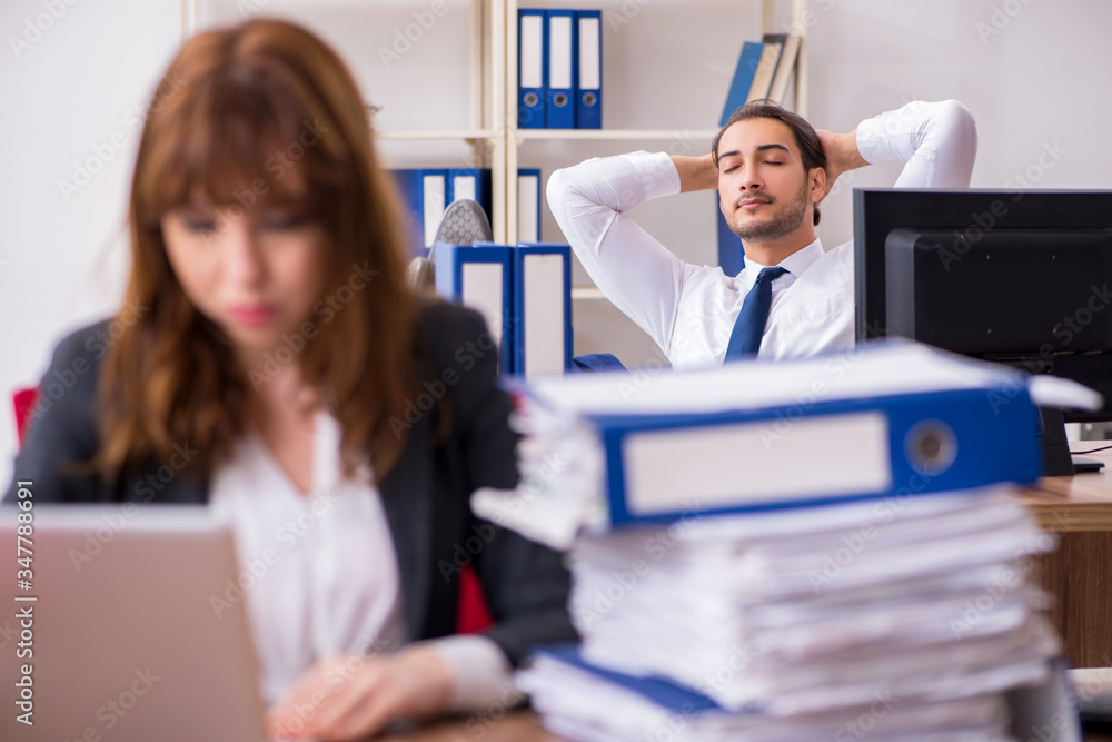 Two employees working in the office Two employees working in the office