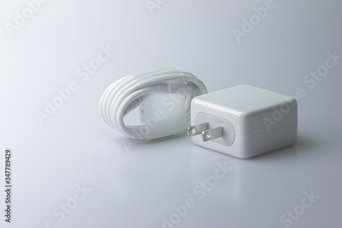 Mobile Phone Charger and USB Type-C Cable for the smartphone on a gray background.