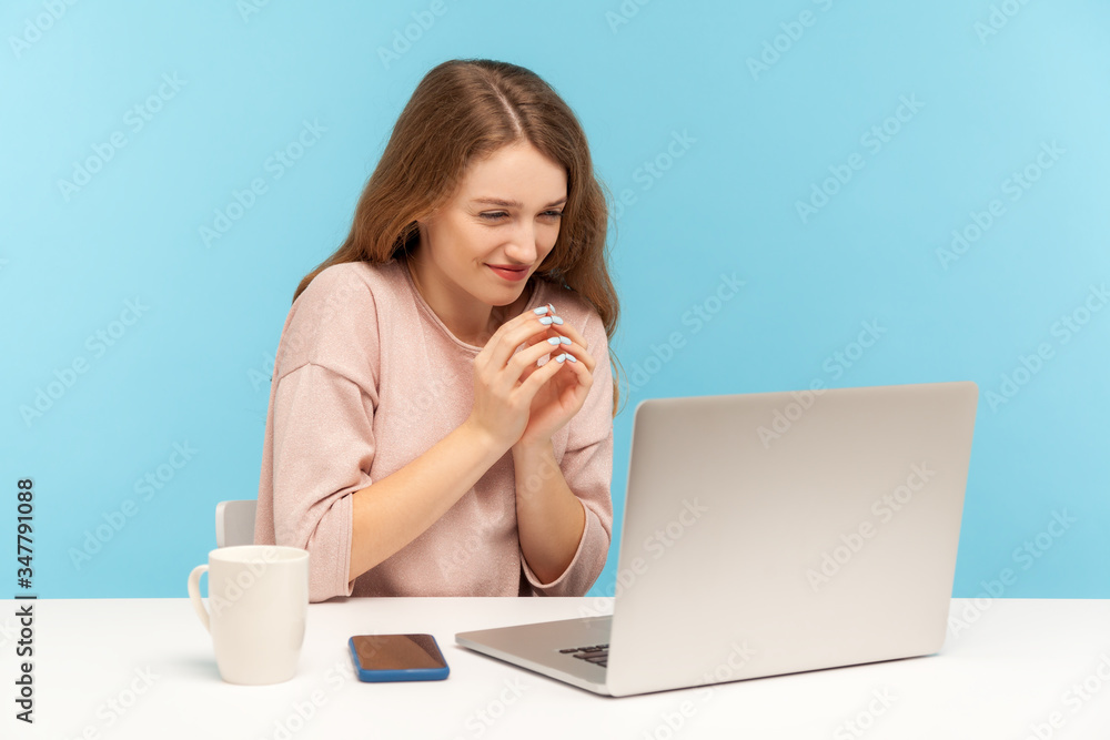 Cunning woman employee with tricky face scheming and conspiring, pondering devious sly business plan while working on laptop, talking on video call. indoor studio shot isolated on blue background Cunning woman employee with tricky face scheming and conspiring, pondering devious sly business plan while working on laptop, talking on video call. indoor studio shot isolated on blue background
