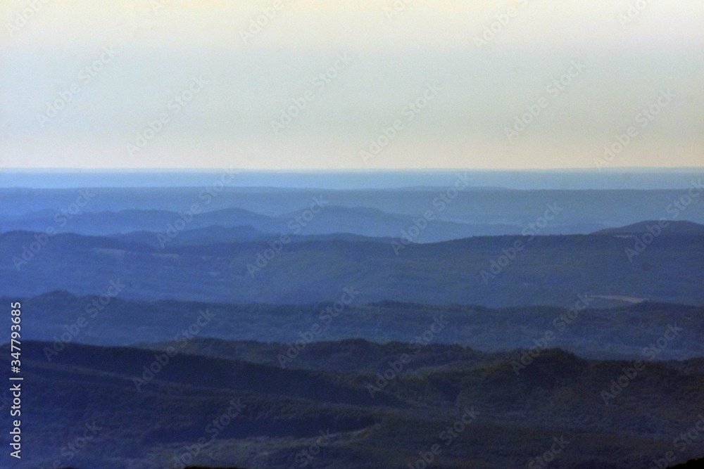 horizon seen from above in top of the mountain on summer day with white clouds and green grass horizon seen from above in top of the mountain on summer day with white clouds and green grass