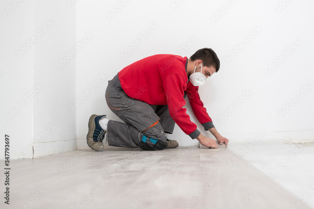 repairman laying flooring