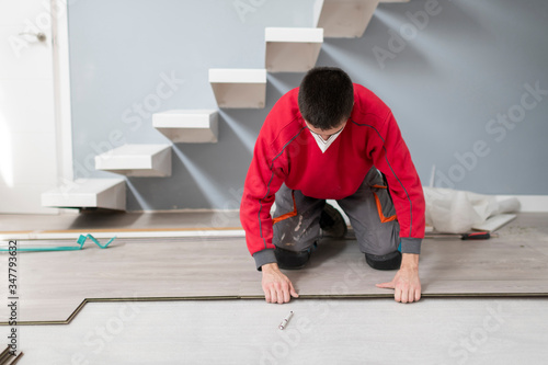 repairman laying flooring