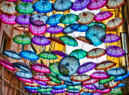 Colorful umbrellas floating above the street
