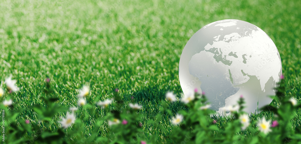 Glass globe or earth in green grass showing eco concept with copyspace, 3d rendering Glass globe or earth in green grass showing eco concept with copyspace, 3d rendering