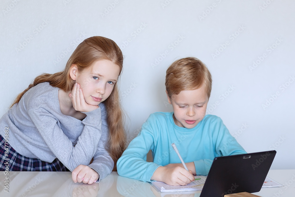 children with a tablet are engaged remotely children with a tablet are engaged remotely