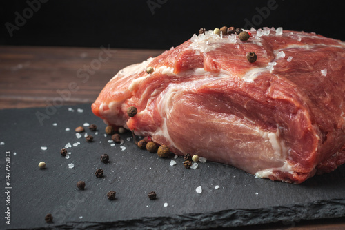 Raw pork chop steak on a black board. Pork antricot